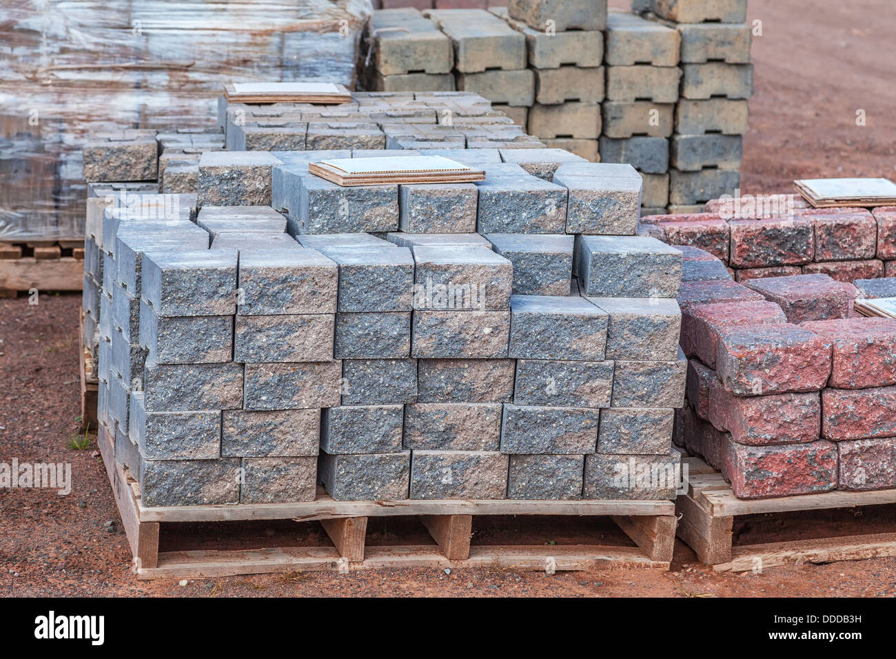 Stacks of various colored concrete pavers (paving stone) or patio blocks  organized on wooden pallets and for sale in a retail se Stock Photo - Alamy