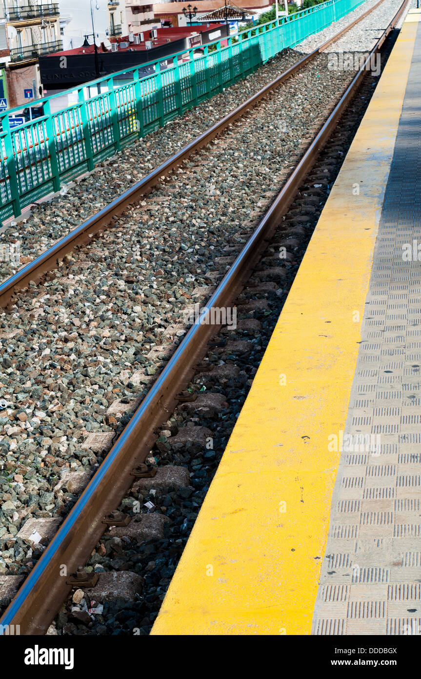 Rainlway line passing through a local station in Spain. Stock Photo