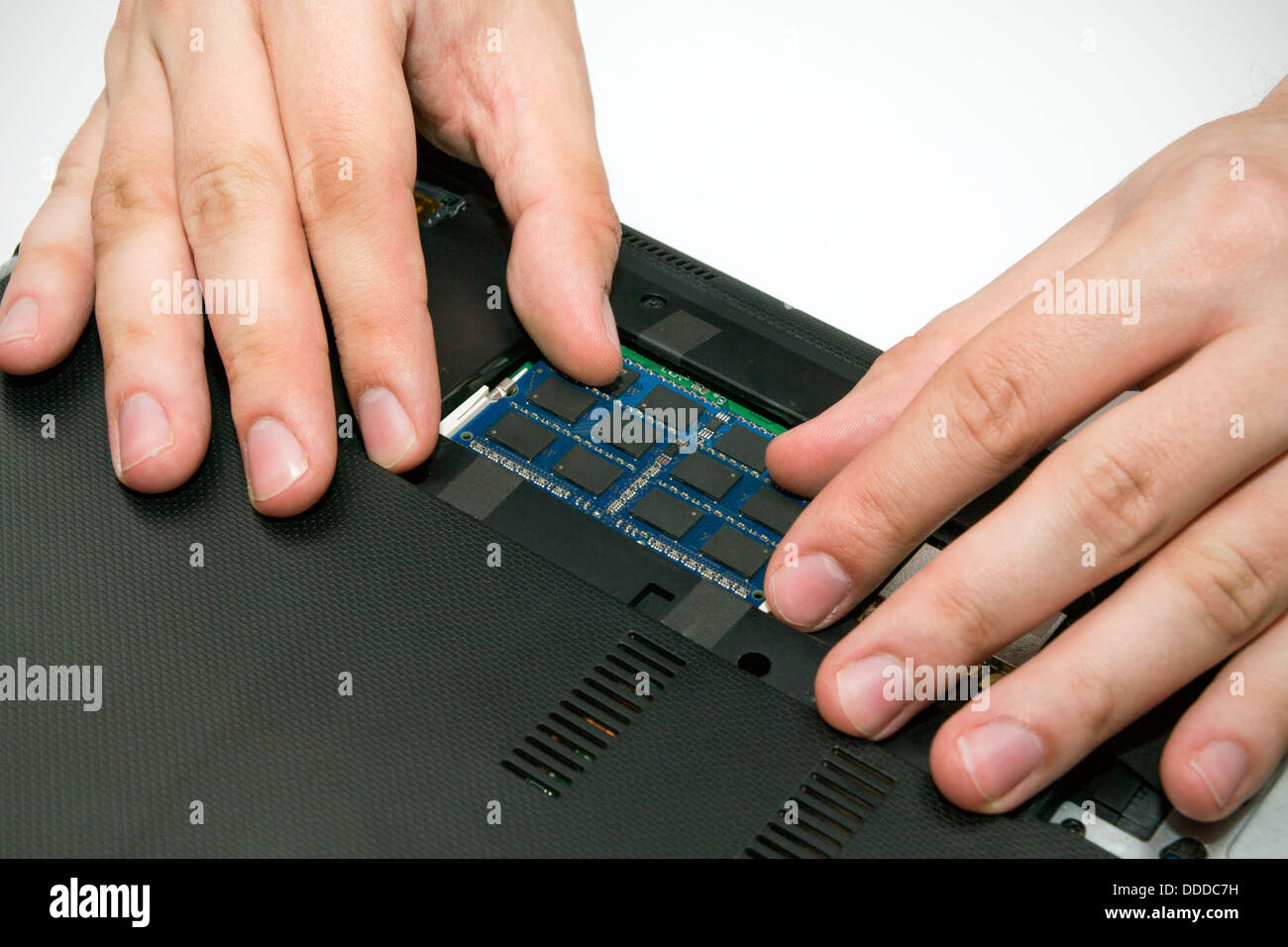 Man installing memory. Laptop RAM upgrade Stock Photo