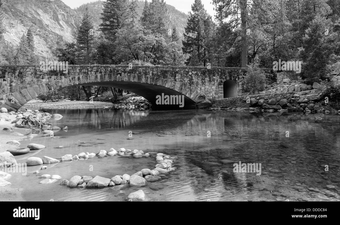 Crystal clear spring and a beautiful stone bridge in Yosemite Valley. Stock Photo