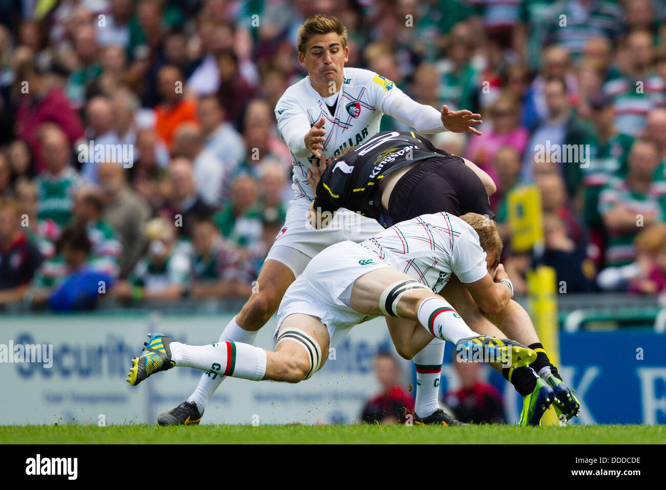 LEICESTER, UK - Saturday 31st August 2013. Tom Croft and Toby Flood tackle and Ulster player. Action from the pre-season friendly between Leicester Tigers and Ulster played at Welford Road, Leicester. Credit:  Graham Wilson/Alamy Live News Stock Photo