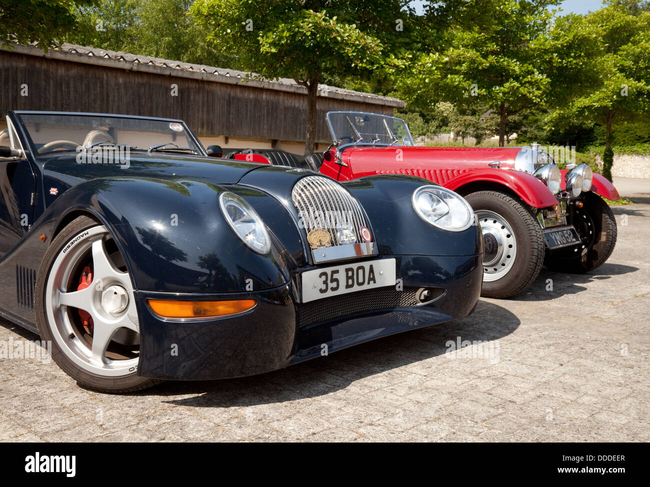 A pair of Morgan sports cars, a modern Aero 8 sports coupe, and an older Morgan, at an owners club rally, Lambourn, Berkshire UK Stock Photo
