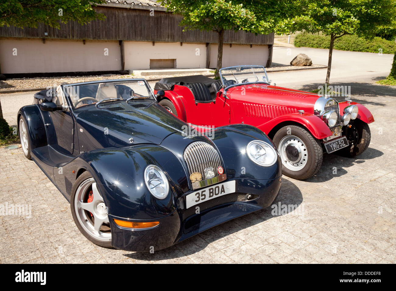 A pair of Morgan sports cars, a modern Aero 8 sports coupe, and an older Morgan, at an owners club rally, Lambourn, Berkshire UK Stock Photo