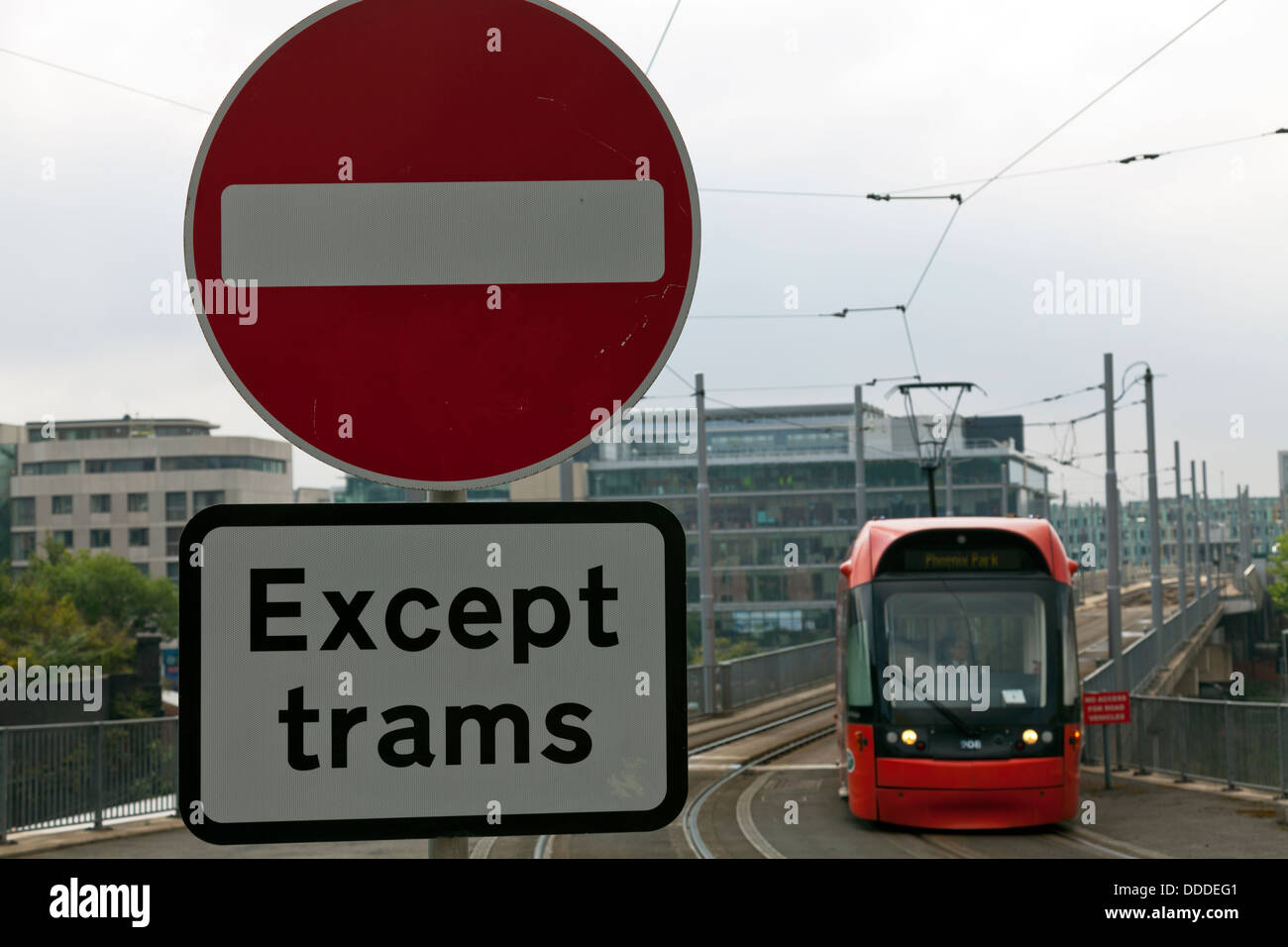 No entry except trams road sign with tram approaching Nottingham City Centre Nottinghamshire UK England Stock Photo