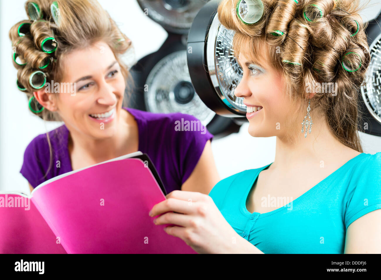 women at the hairdresser reading a magazine or a rag and chitchat