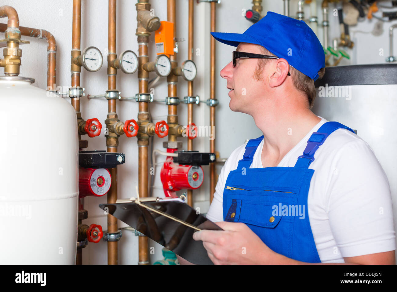 Engineer controlling the heating pipes at the boiler room Stock Photo