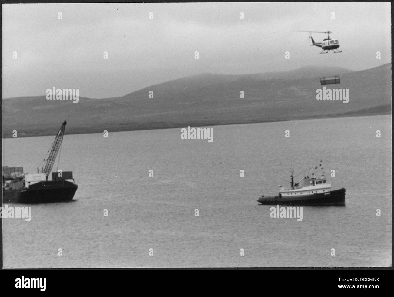 A cargo helicopter in operation, transporting goods or equipment ...
