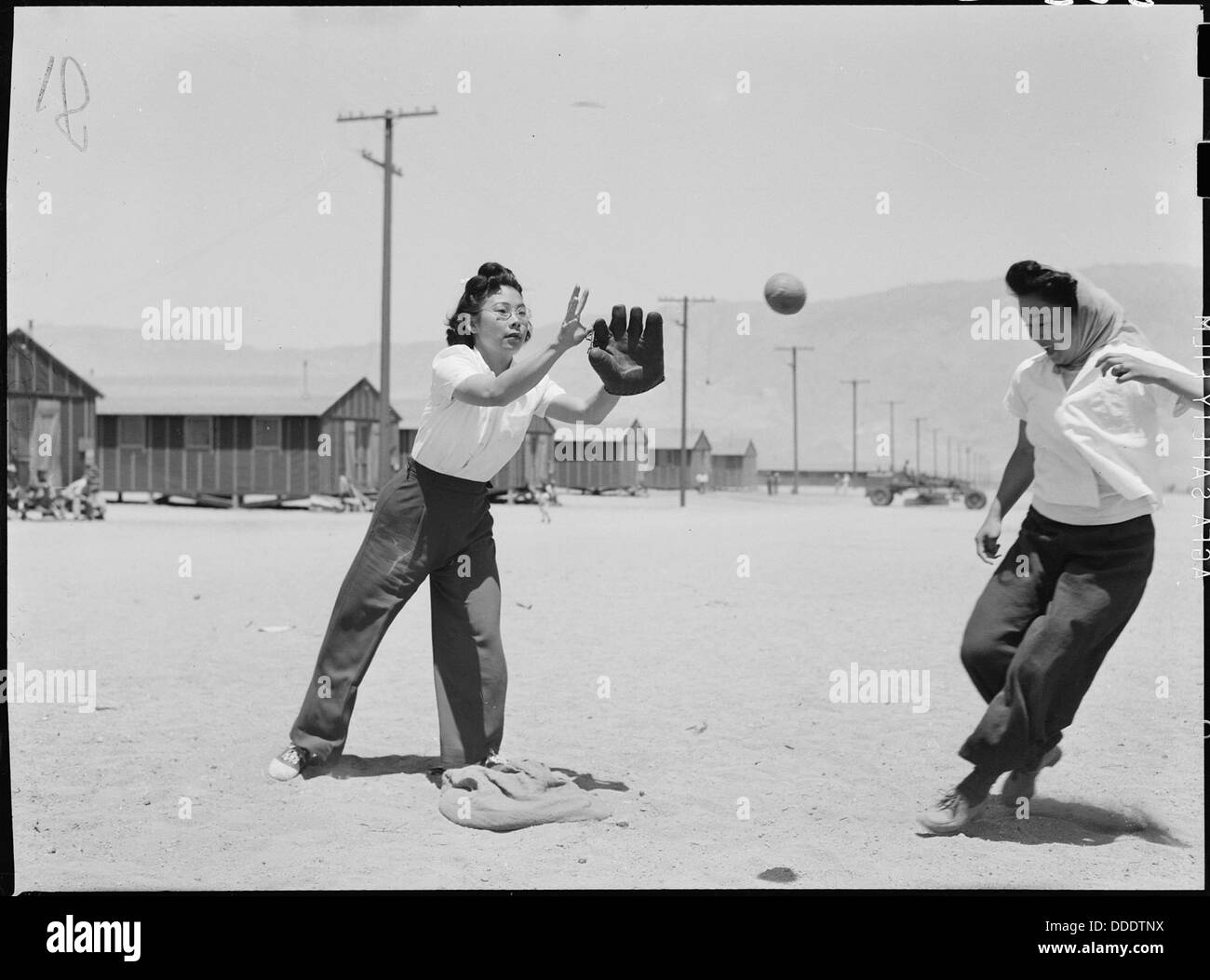 Manzanar Relocation Center, Manzanar, California. A close play at third base in a practice game bet . . . 538497 Stock Photo