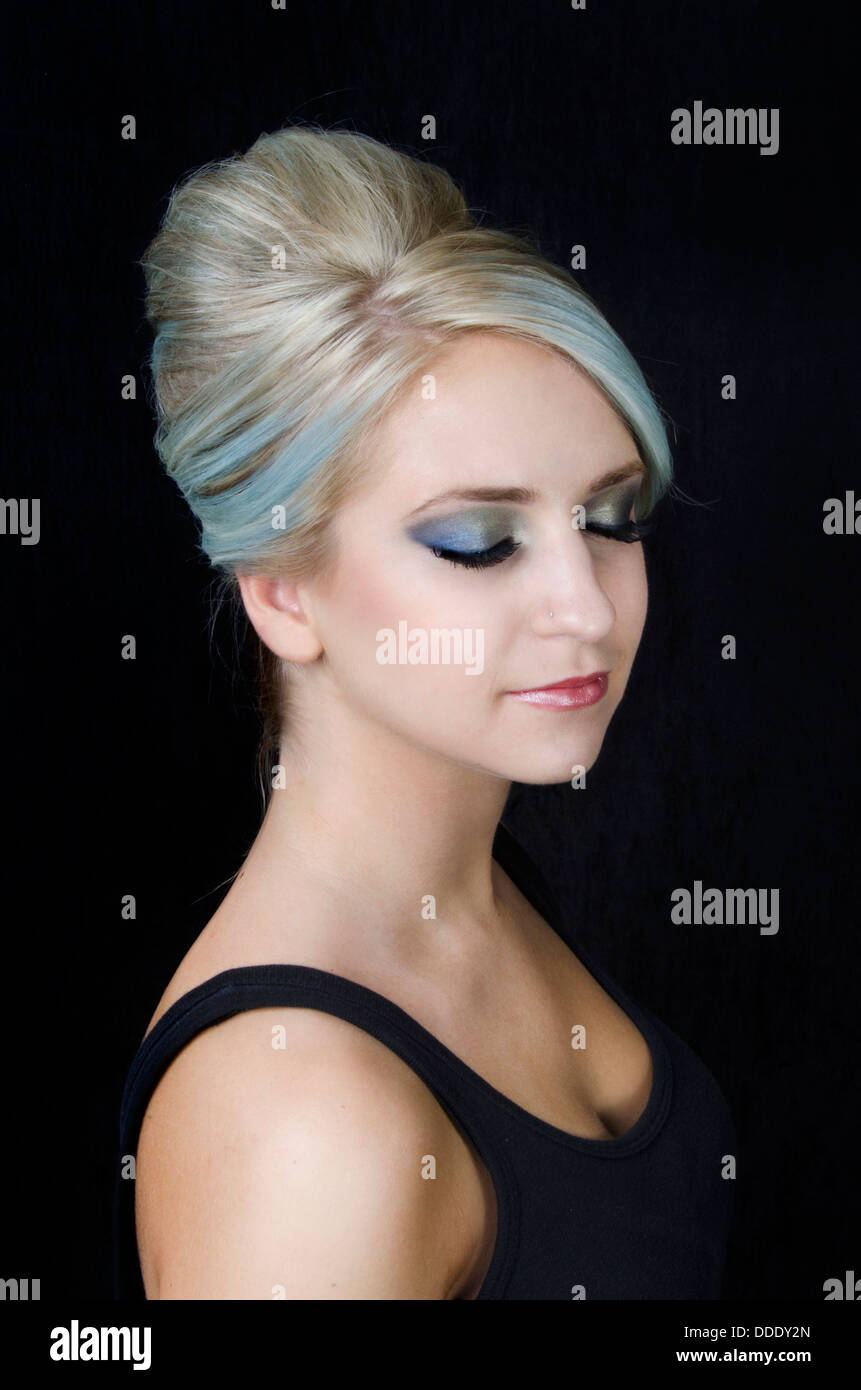 A young beauty model with blue blonde cooltone hair in an elegant up-do in a studio setting Stock Photo