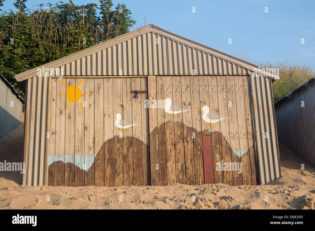 Abersoch beach hut with painting of seagulls perched on rocks on beach on doors Llŷn Peninsula Gwynedd North Wales UK Stock Photo