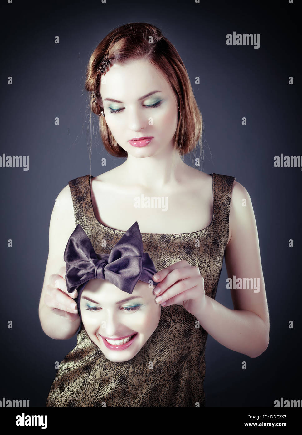 sad girl with a cheerful face mask (concept Stock Photo Alamy