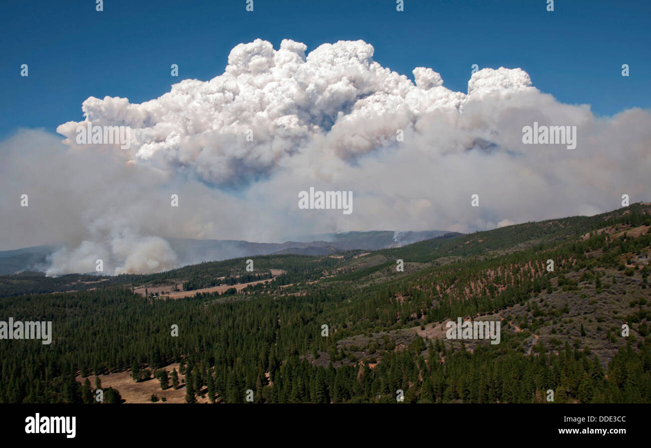 Flames and smoke from the Rim Fire continues to burn August 20, 2013 near Yosemite, CA. The fire continues to burn old growth forest and threaten Yosemite National Park. Stock Photo