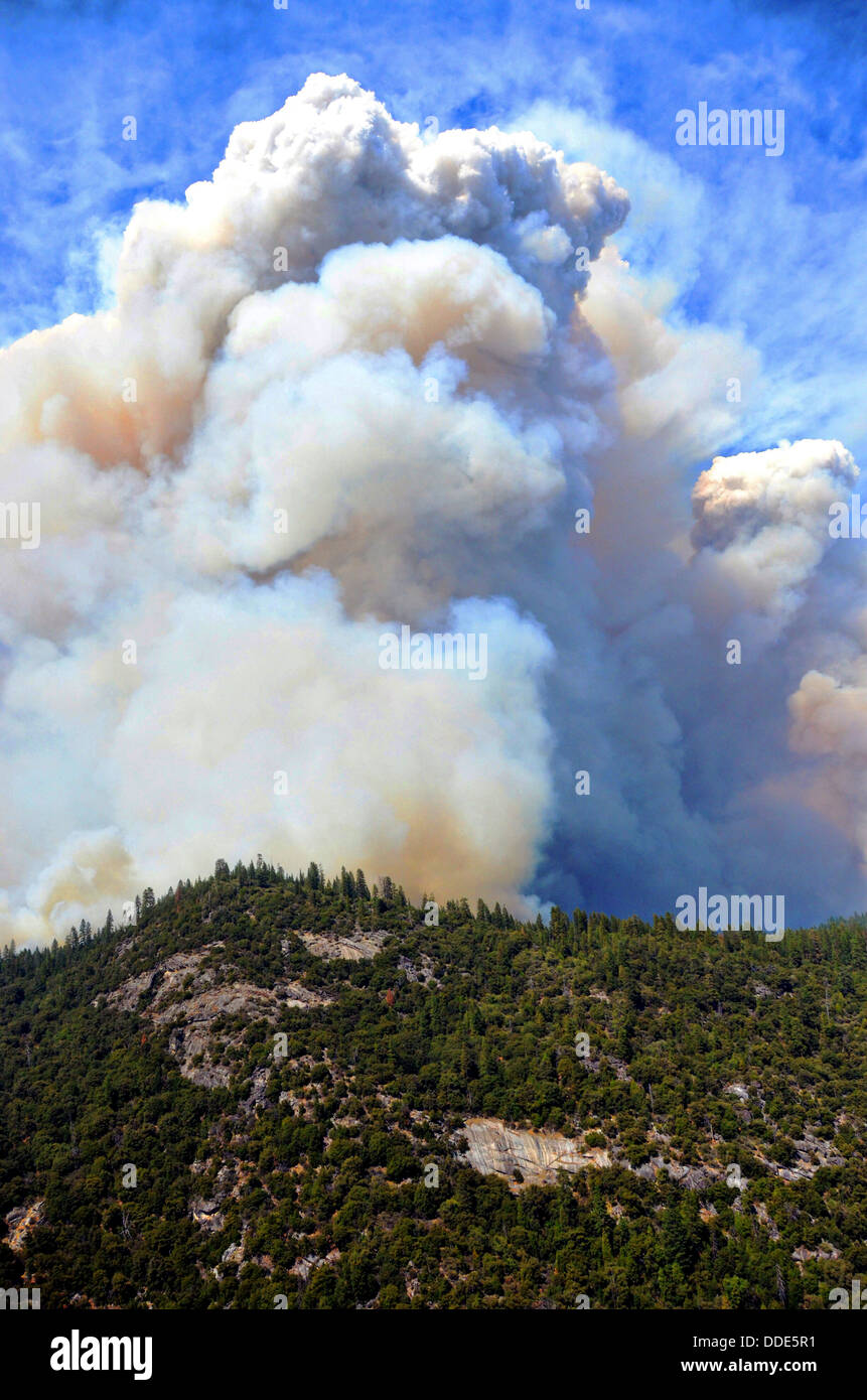 Flames and smoke from the Rim Fire continues to burn August 26, 2013 near Yosemite, CA. The fire continues to burn old growth forest and threaten Yosemite National Park. Stock Photo