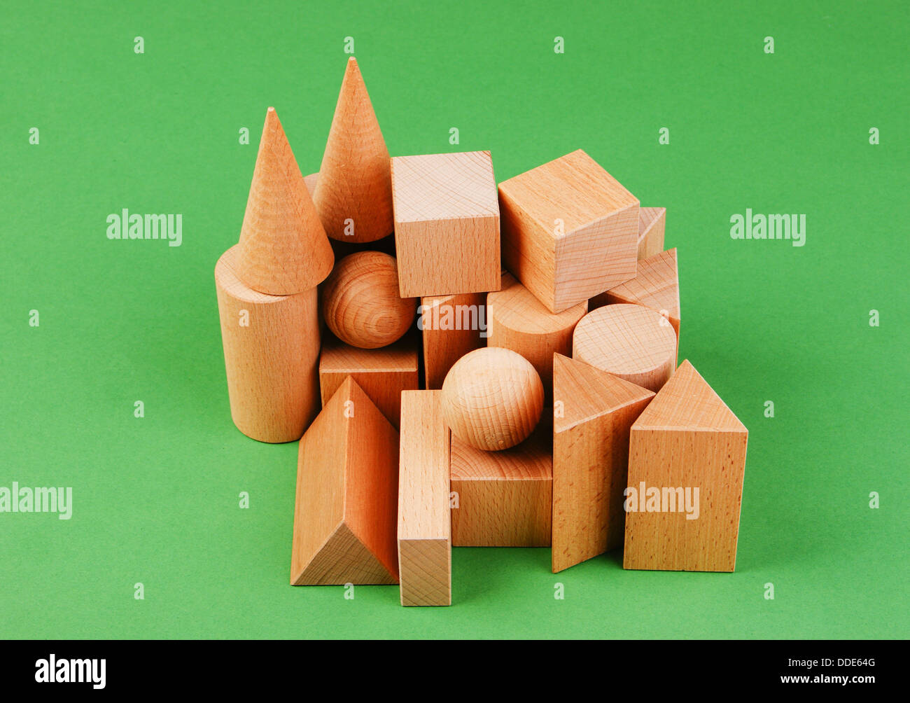 wooden geometric shapes on a green background Stock Photo Alamy