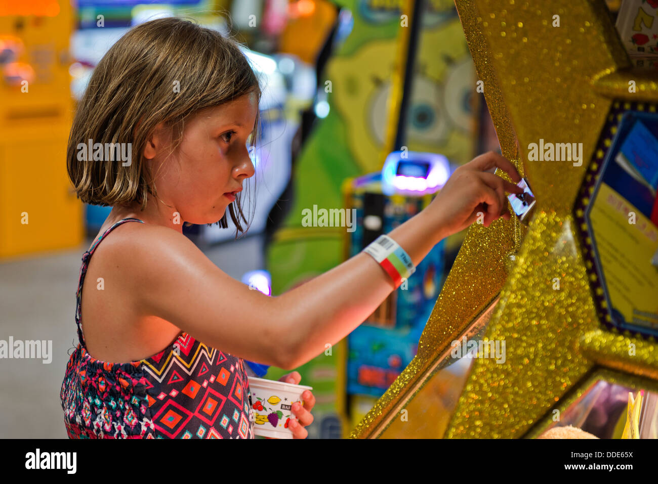 Model released image of a young girl playing in the amusement arcades at Southend on Sea, Essex. Stock Photo