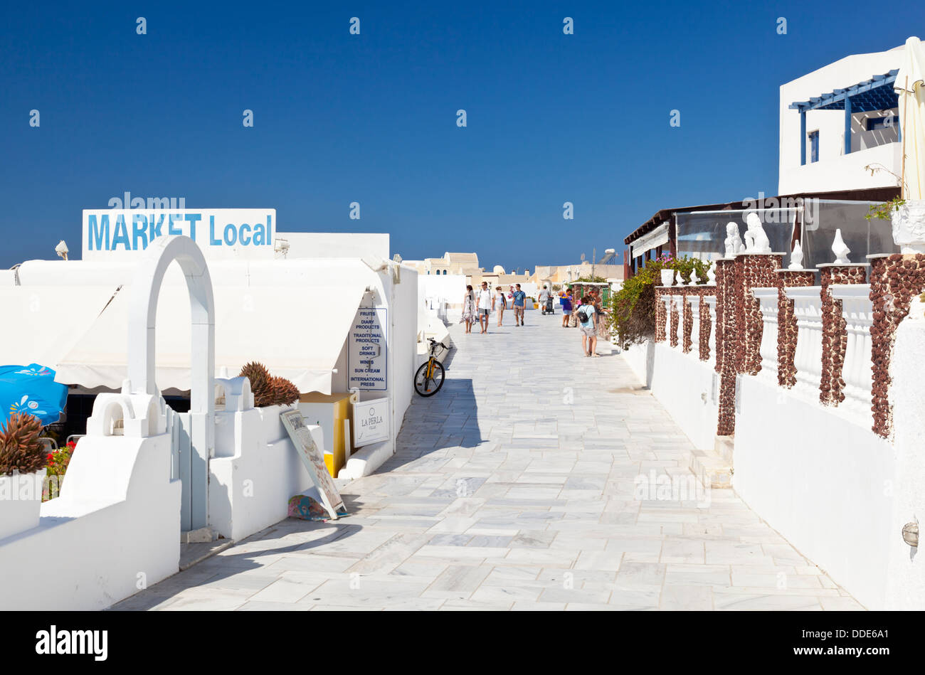 Oia streets with some tourists Santorini, Greece. Stock Photo