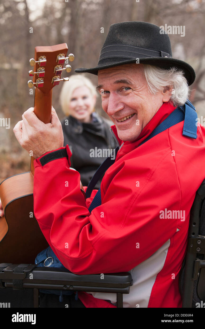 Musician With Multiple Sclerosis In A Motorized Wheelchair With His 