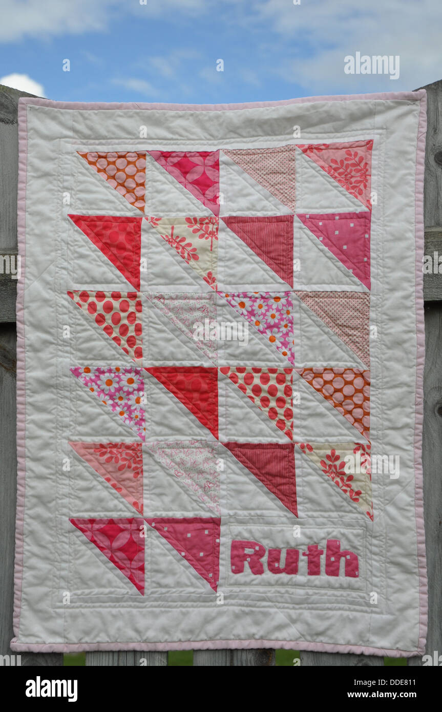 Pink and white baby girl quilt with triangles Stock Photo