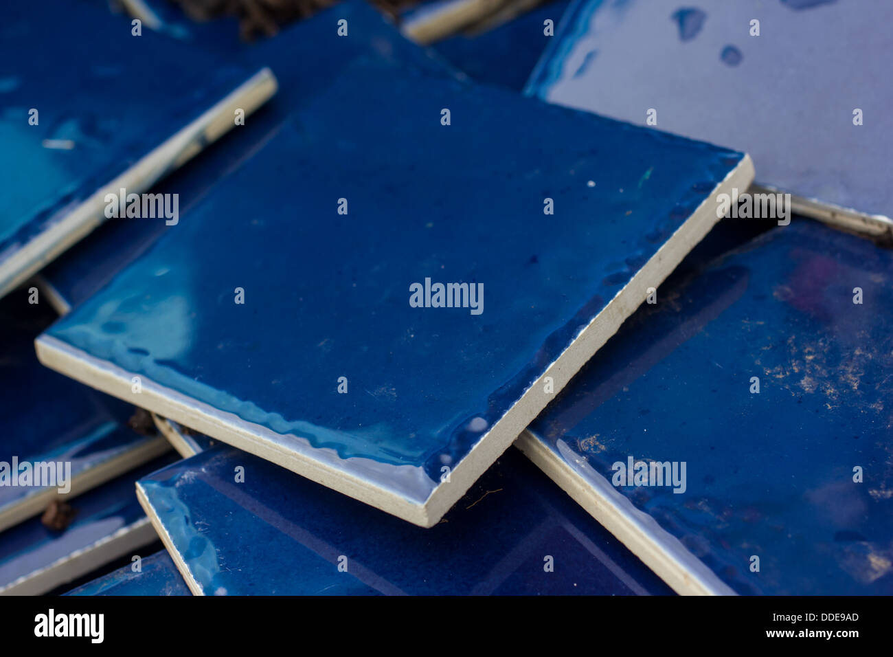 A full frame image of blue tiles that are arranged in a random pile Stock Photo