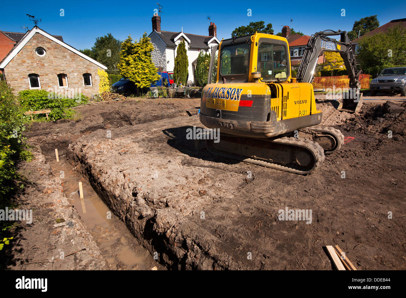Al844 self building house, preparing site, volvo digger digging trench for foundations Stock Photo