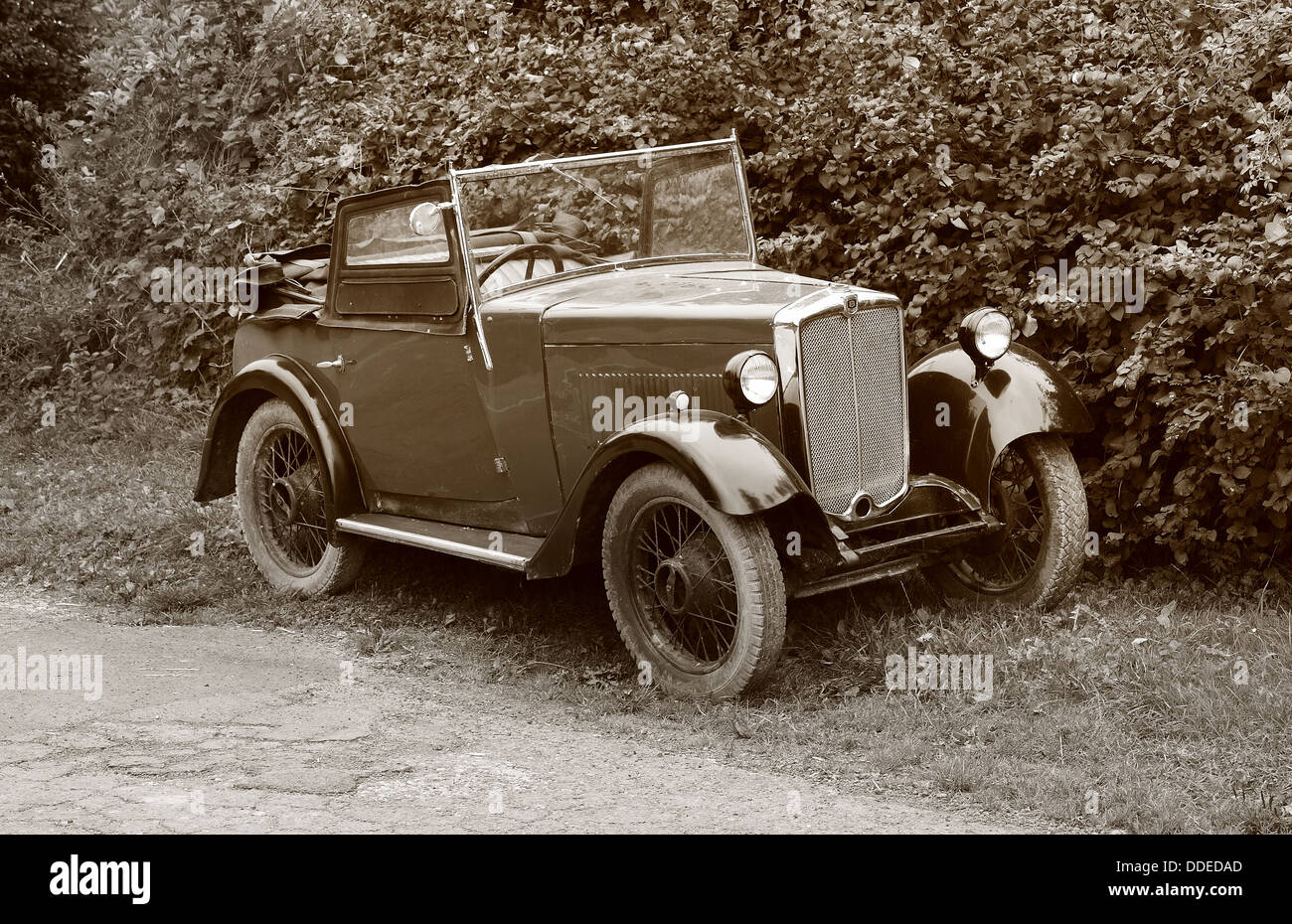 Sepia image of a Vintage British Morris Motor Car parked on a quiet English lane Stock Photo
