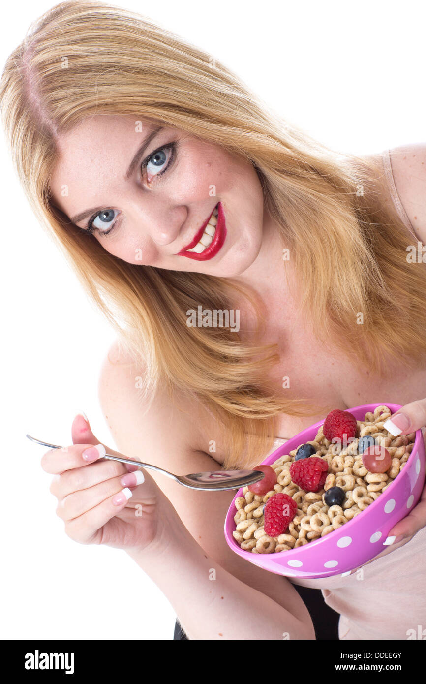 Model Released. Attractive Young Woman Eating Breakfast Cereal Mixed Berries Stock Photo