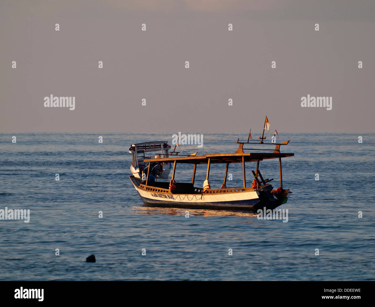 Boat in the sea in sunset light Stock Photo - Alamy