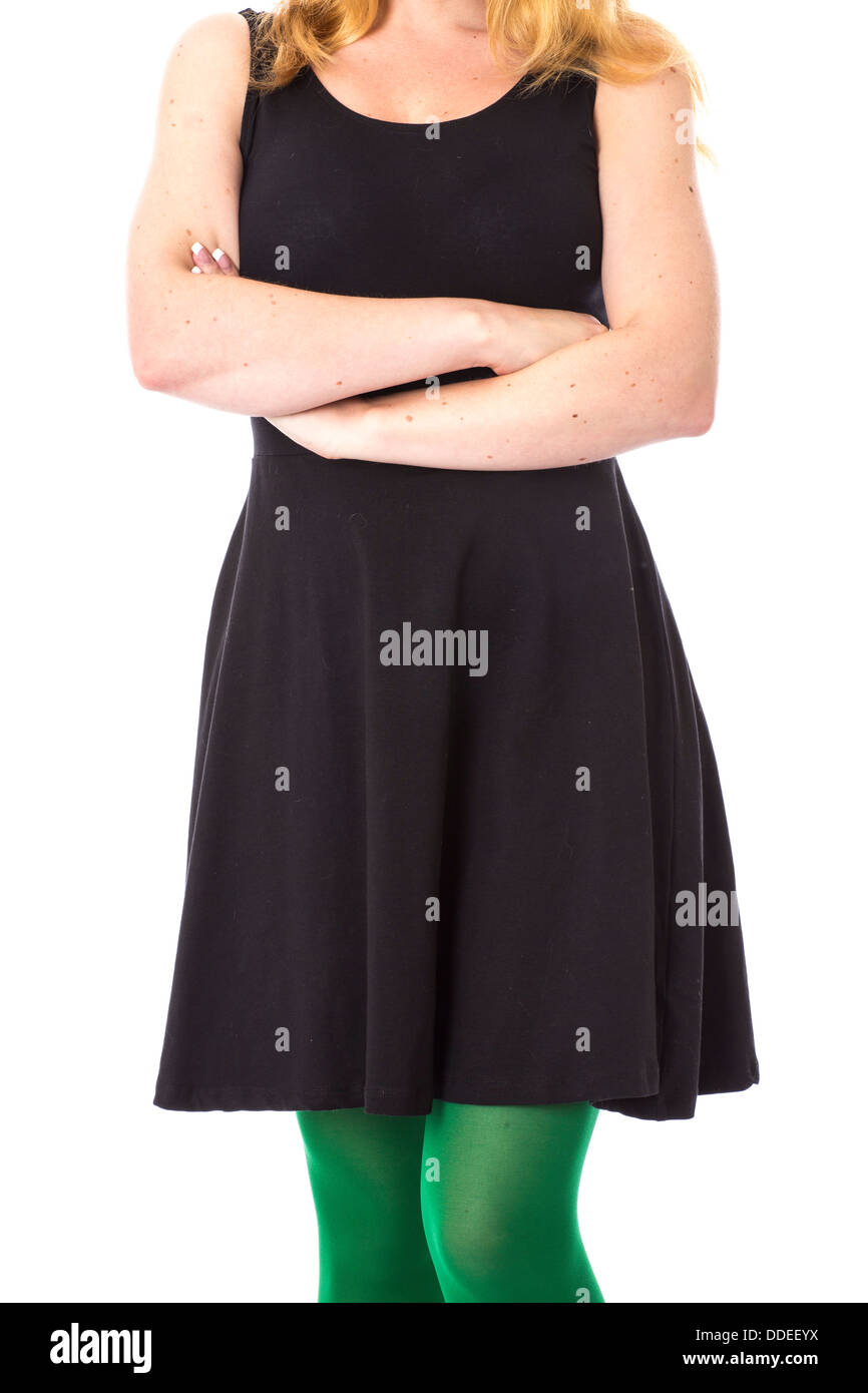 Model Released. Young Woman Wearing a Black Dress and Green Tights Stock Photo