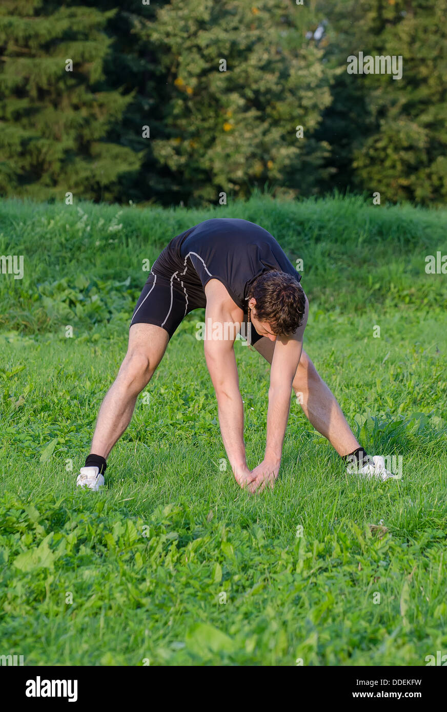 Young sportsman stretching hi-res stock photography and images - Alamy