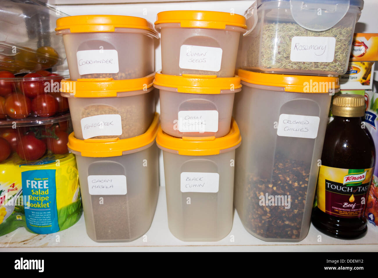 Tupperware storage containers in a cupboard. Stock Photo