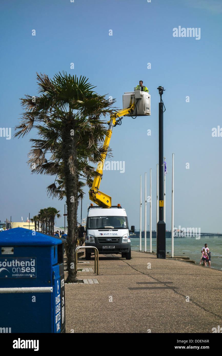 Cherry picker or bucket truck maintaining a security camera. Maintenance repairing, on Southend seafront. Stock Photo