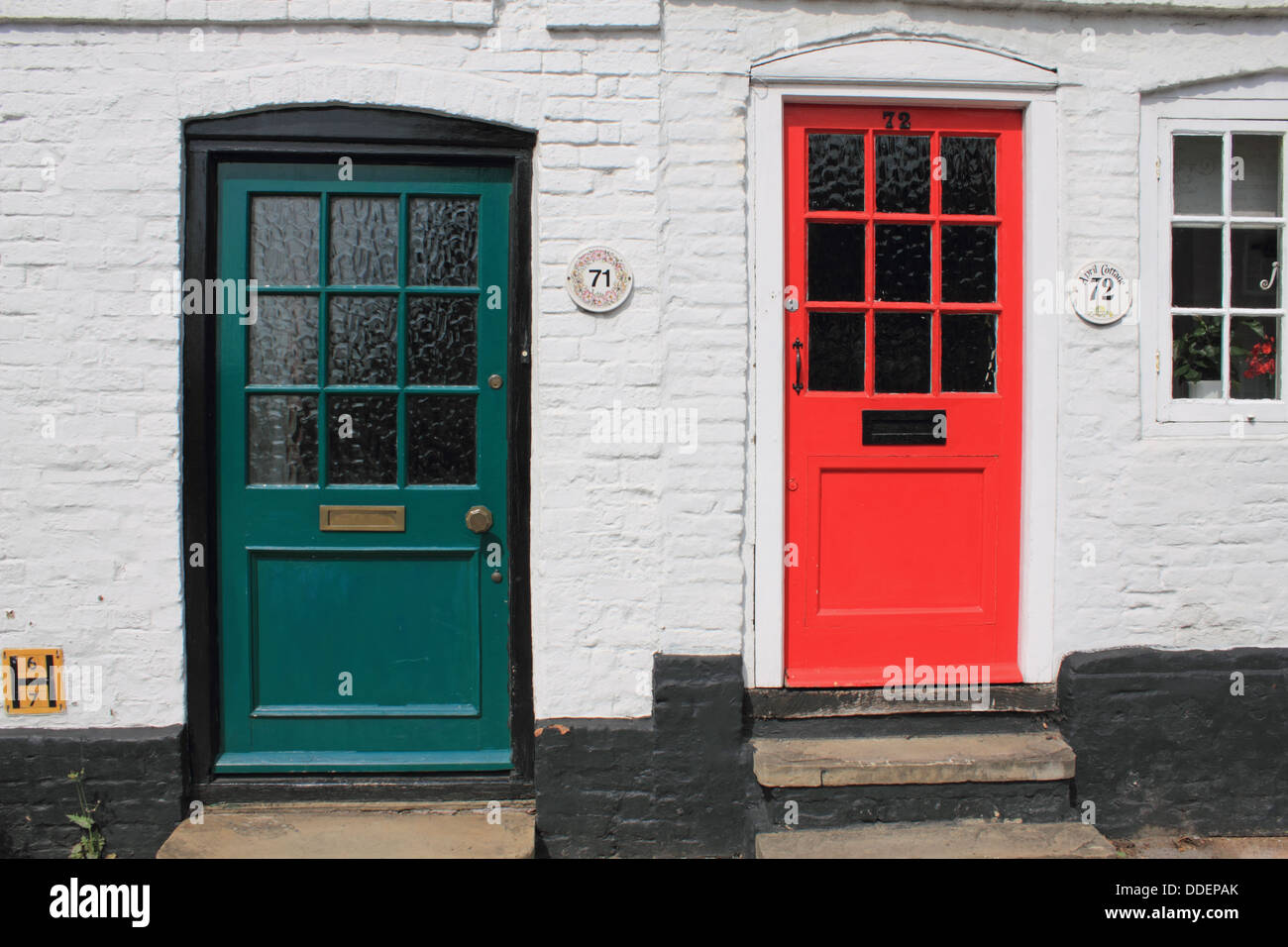 Red and green front doors on terraced houses in Farnham, Surrey, England, UK. Stock Photo