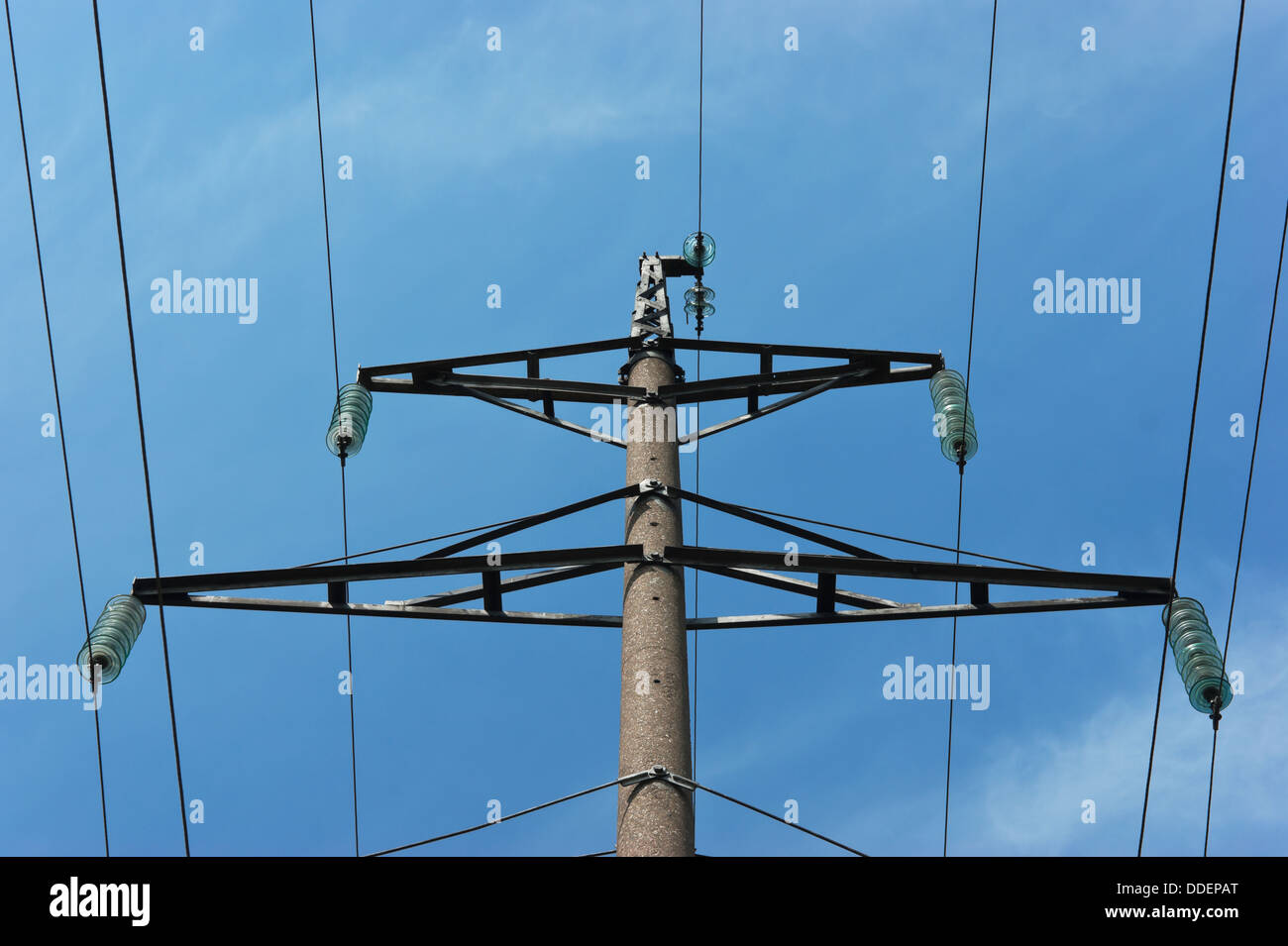 High voltage power pole against the blue sky Stock Photo - Alamy