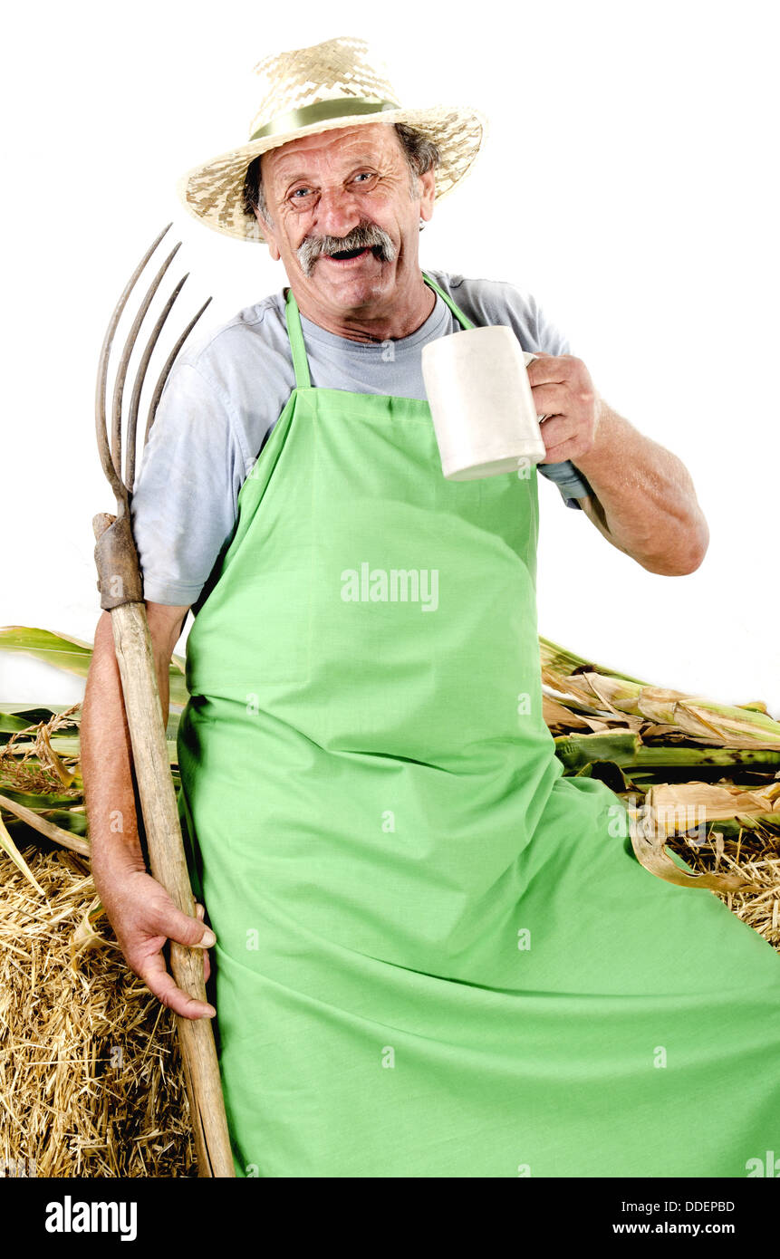 organic farmer with a pitchfork and a beer mug Stock Photo