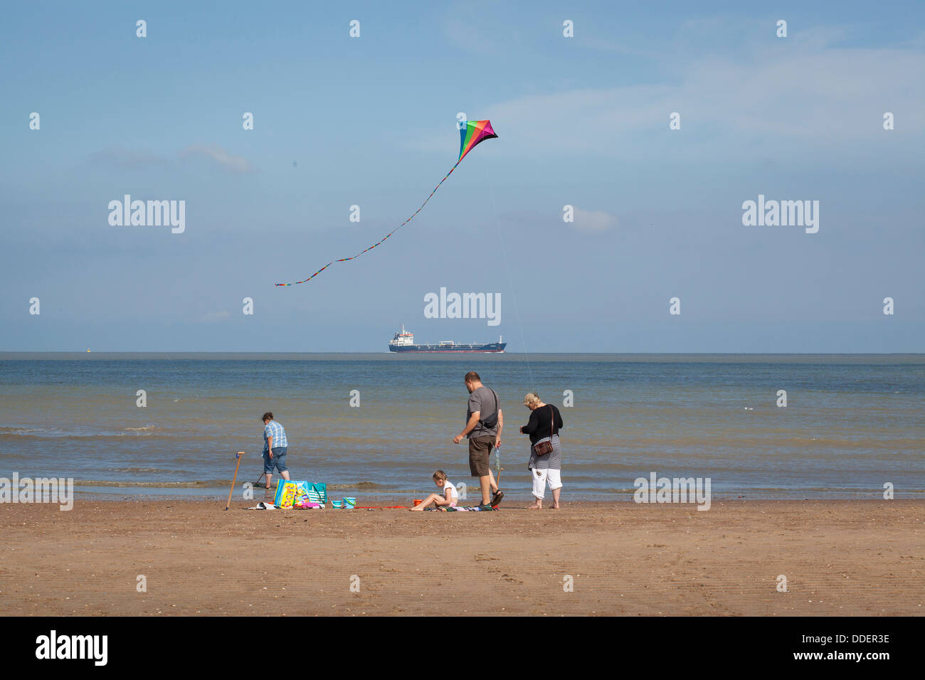 Family playing with a kite on the beach at Cadzand at the North Sea Stock Photo