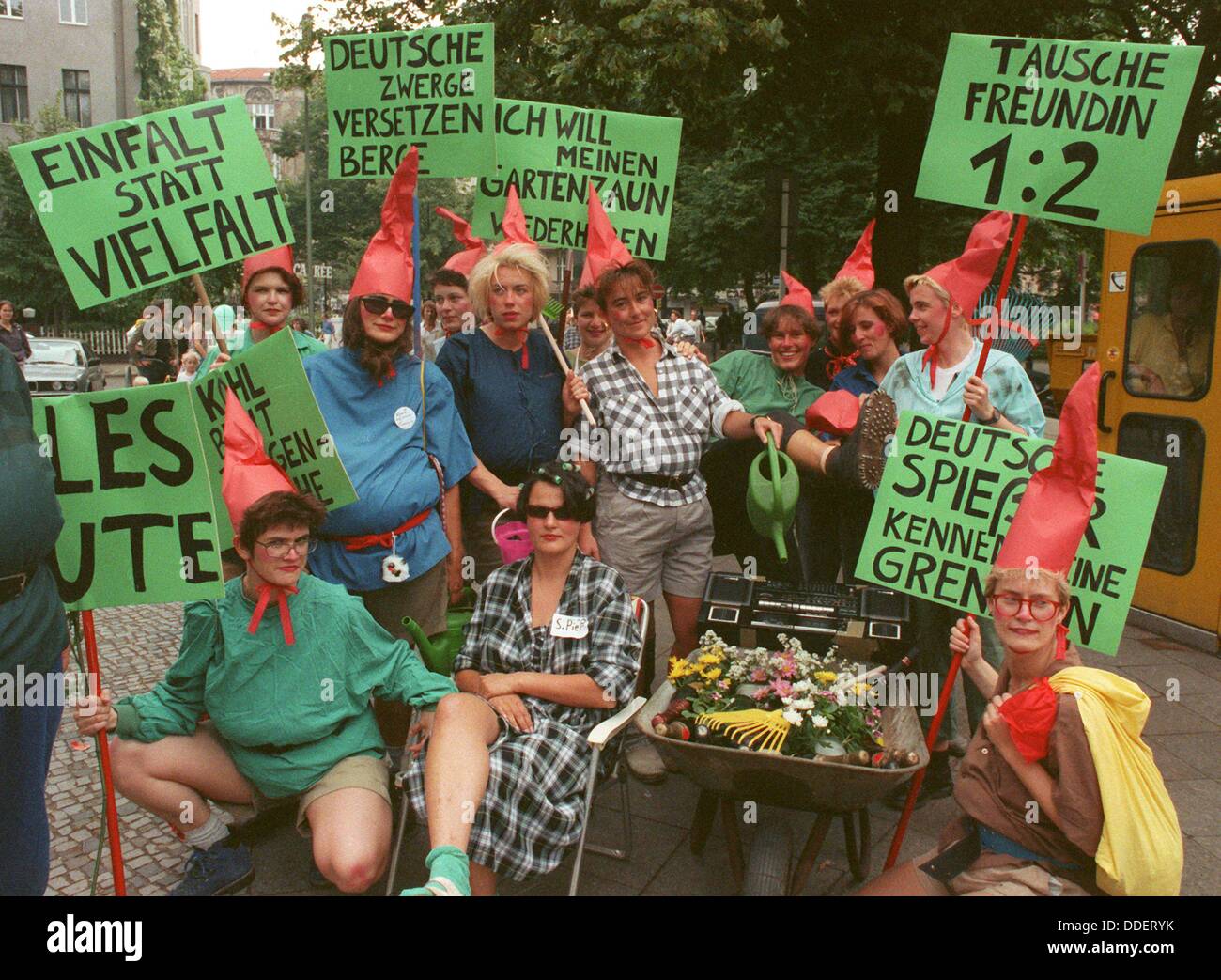 These young people dressed as garden gnomes mock the monetary union between the two German states with banners translating 'I want my garden fence back' and more on July 1st 1990. The treaty between the two German states on the monetary, economical and and social insurances union came into effect the same day causing a real rush demand at banks all over the GDR. An estimated 2,6 billion Deutsch Mark were dealt out to GDR citizens within the first hours of the same day. Stock Photo