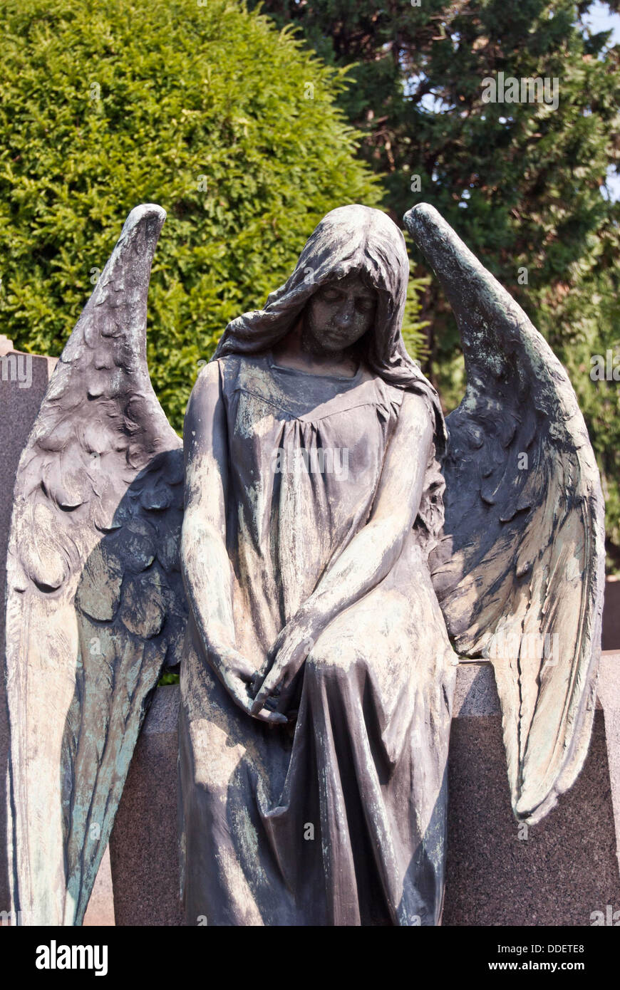 Statue of an angel on a grave at the monumental cemetery of Milan Stock