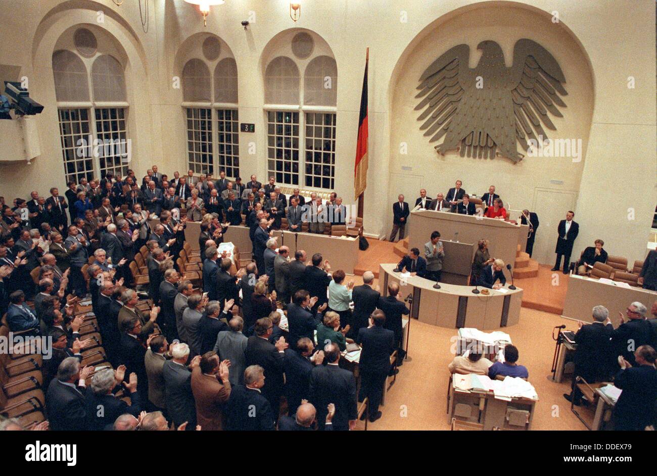 Members of the Bundestag stand up and sing the national anthem after the speaker announced the positive result of the vote on the unification treaty in Bonn, Germany, 20 September 1990. The same day GDR 'Volkskammer' (Parliament) in Berlin voted in favour of the treaty with a two-thirds majority as well. The results of the vote in detail: Bundestag (vote by name): 442 mps voted in favour, 47 against the treaty, three abstained from voteing. GDR Volkskammer: 299 mps voted in favour, 80 against the treaty and one abstained from voting. Stock Photo