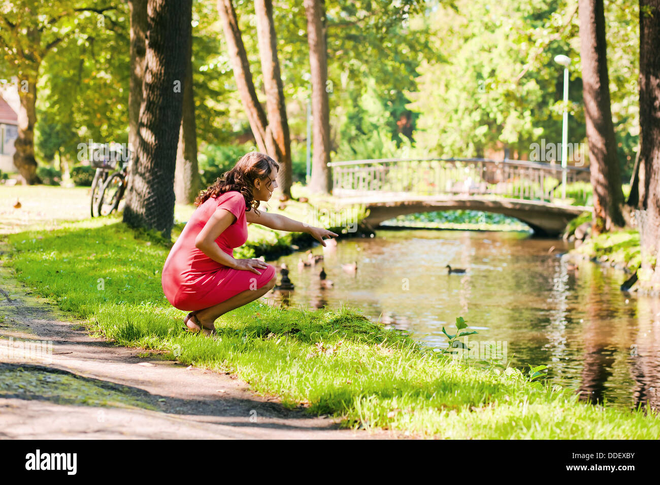 The young pregnant woman on walk in park Stock Photo - Alamy