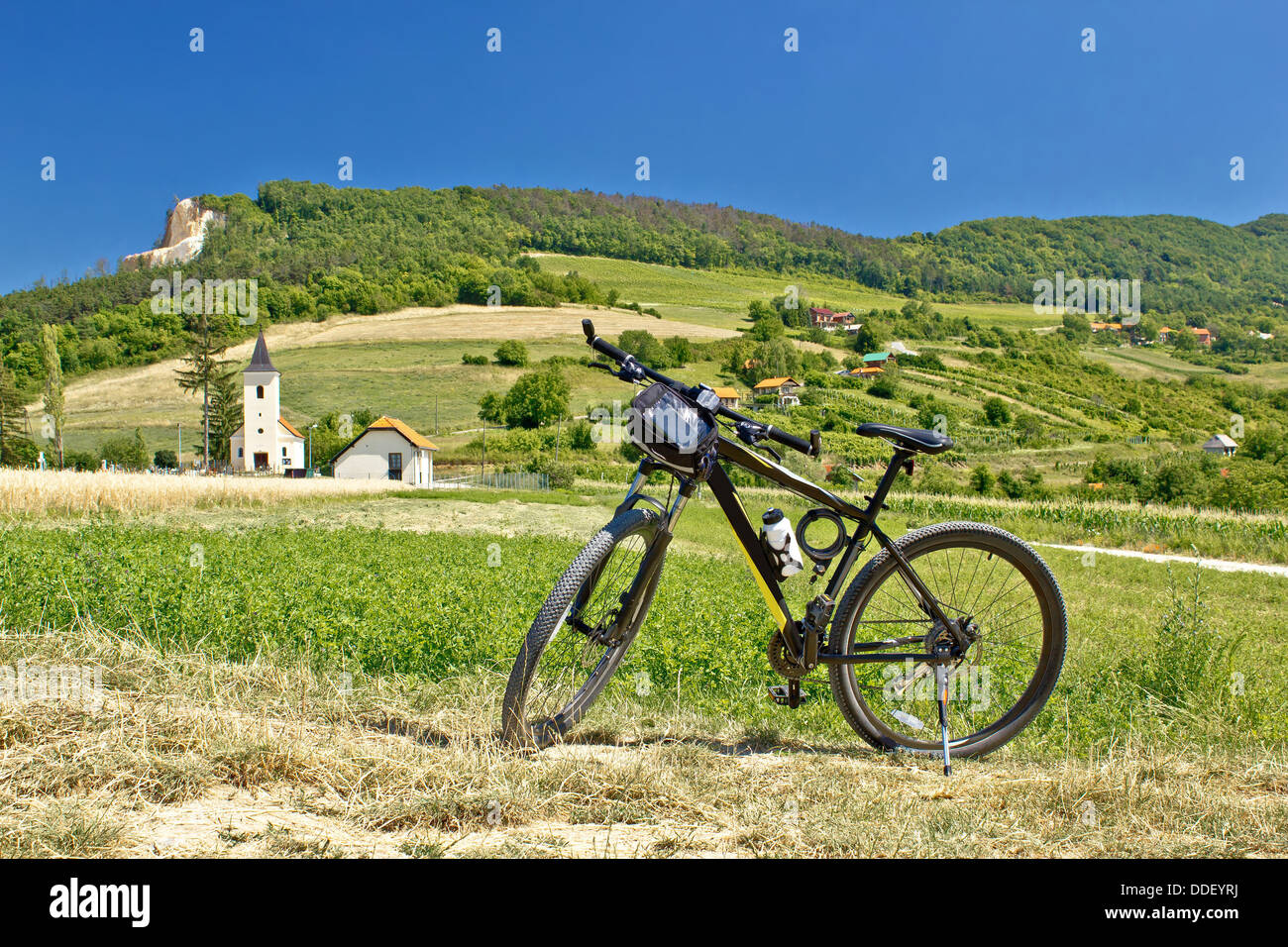 Mountain bike in green landscape, fields, nature Stock Photo