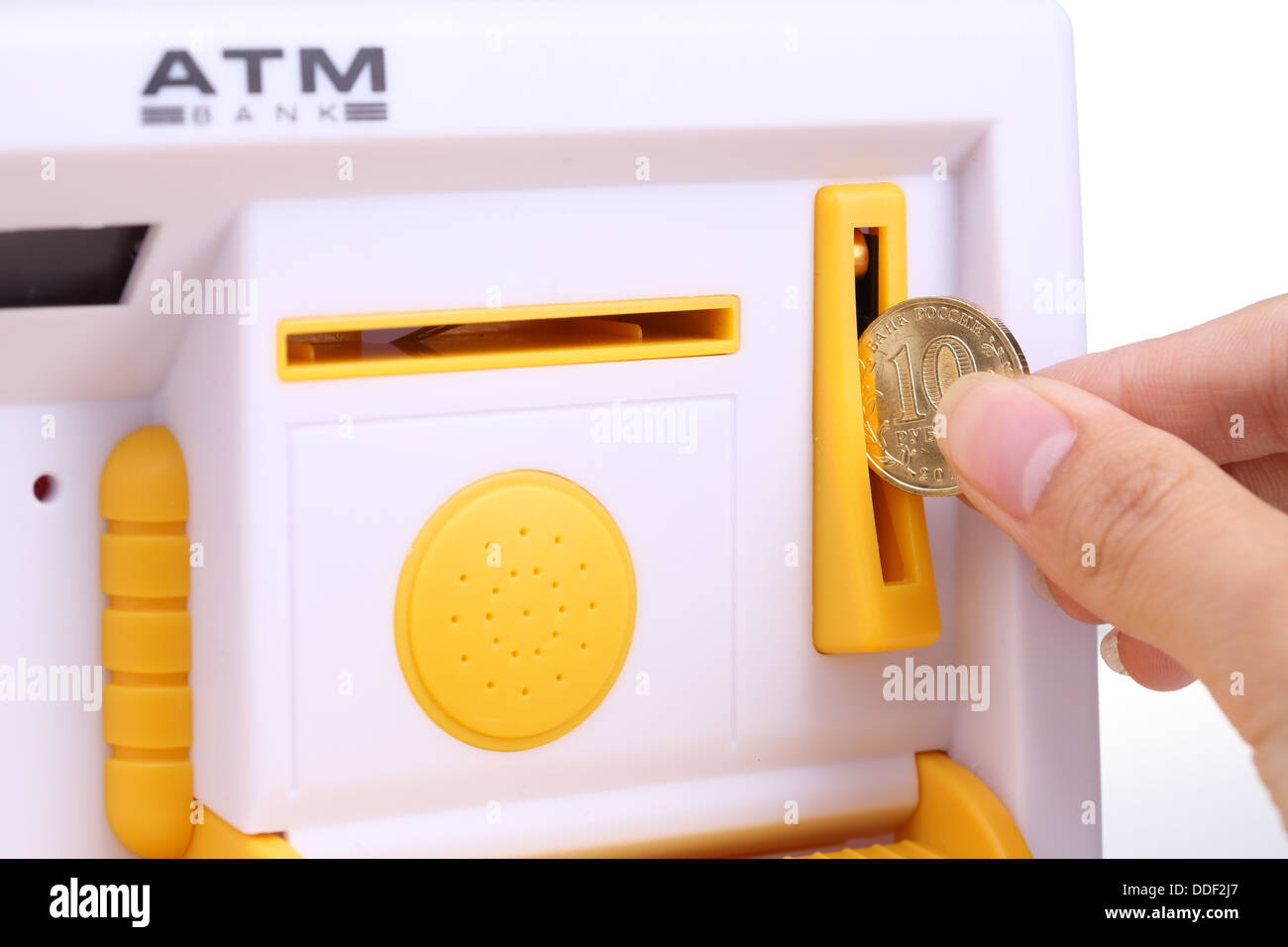 Hand holding the coins into ATM Stock Photo Alamy