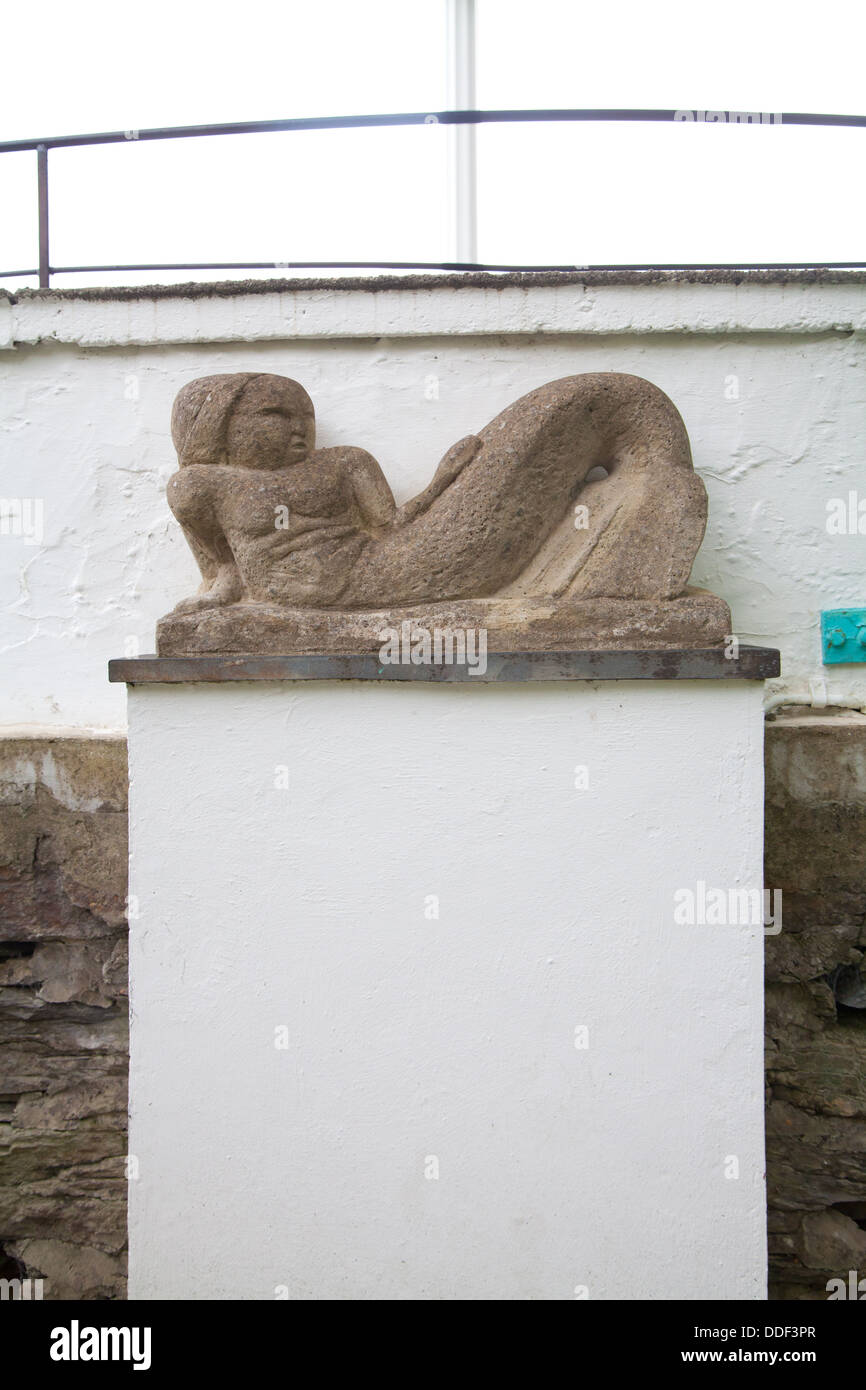 Stone carving / statue of a reclining woman / mermaid in Portmeirion Village Stock Photo