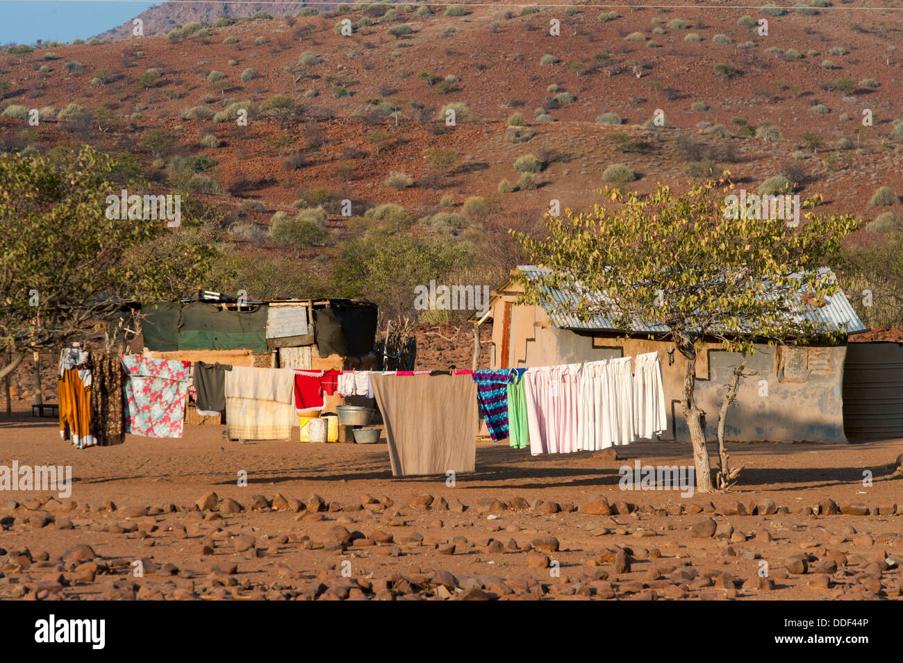 Farmstead with laundry hanging to dry set in a dry landscape, Kunene Region, Namibia Stock Photo