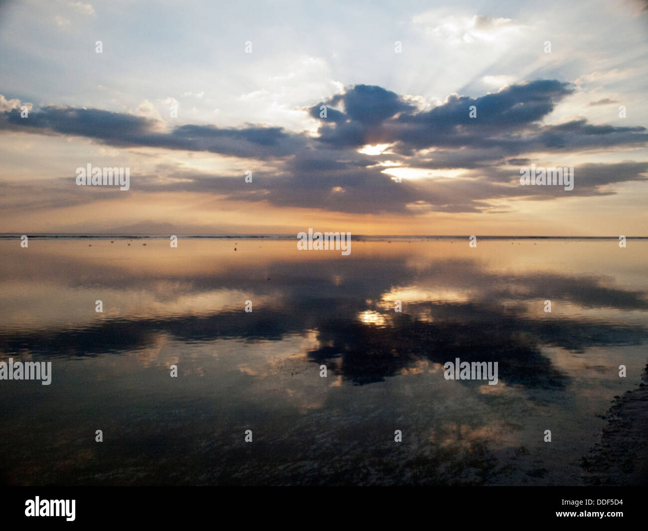 Sunset reflection in the coral reef sea in Gili Trawangan Stock Photo