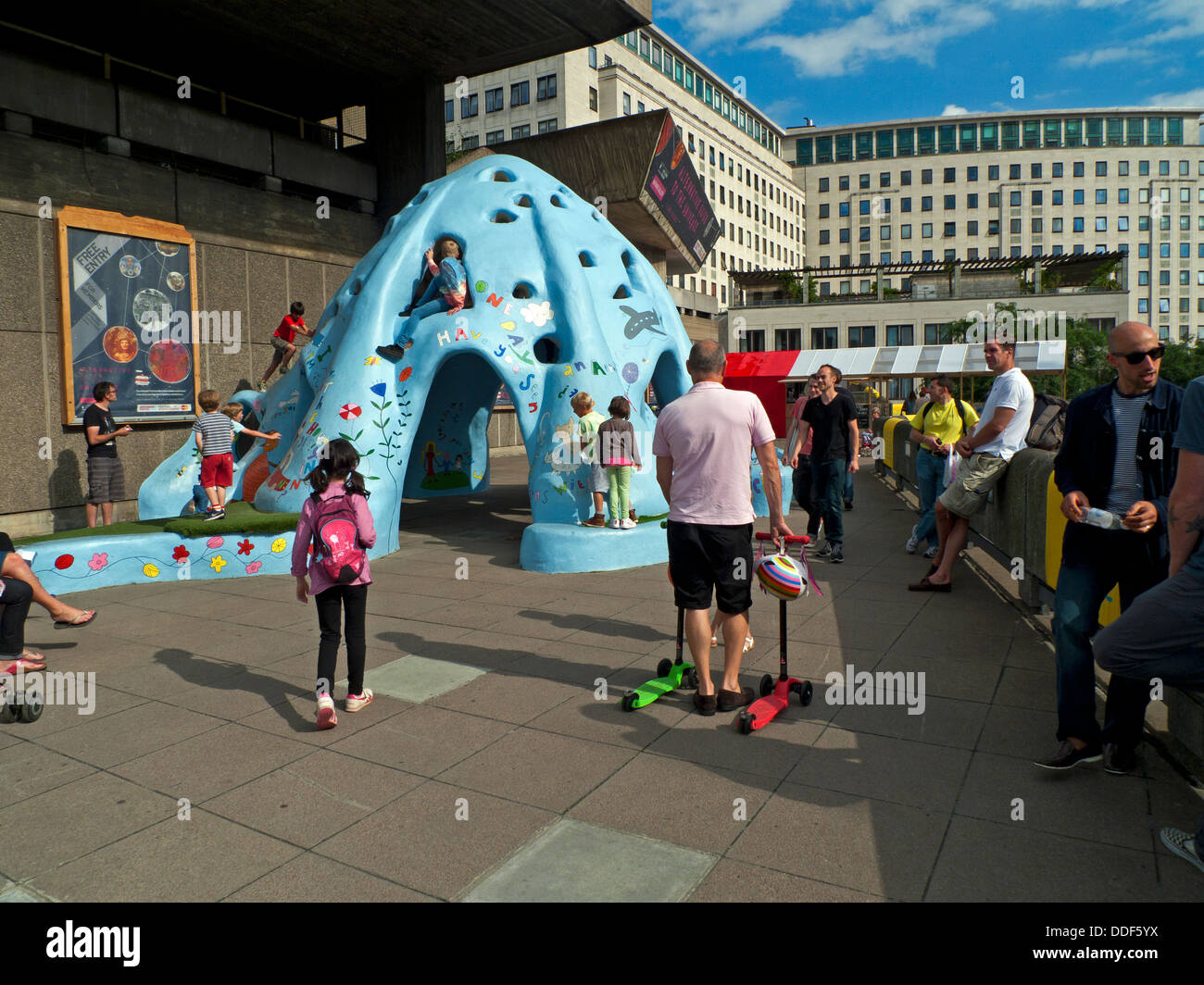 Parents watching children playing on climbing structure at summer kids festival  Southbank London England UK   KATHY DEWITT Stock Photo