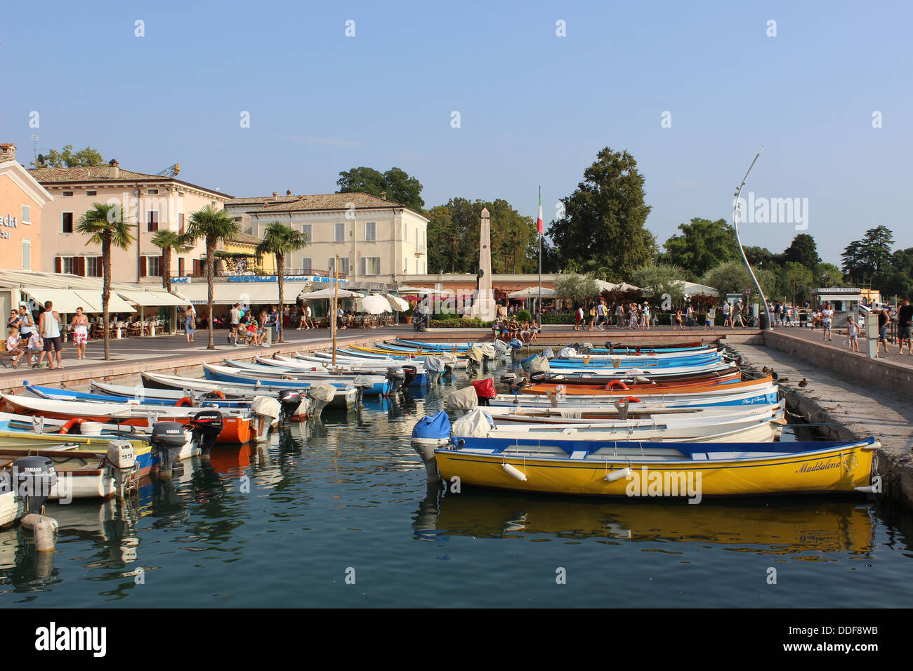 Small boats moored in the harbor at Bardelino on Lake Garda in Italy on a sunny summer day. Stock Photo