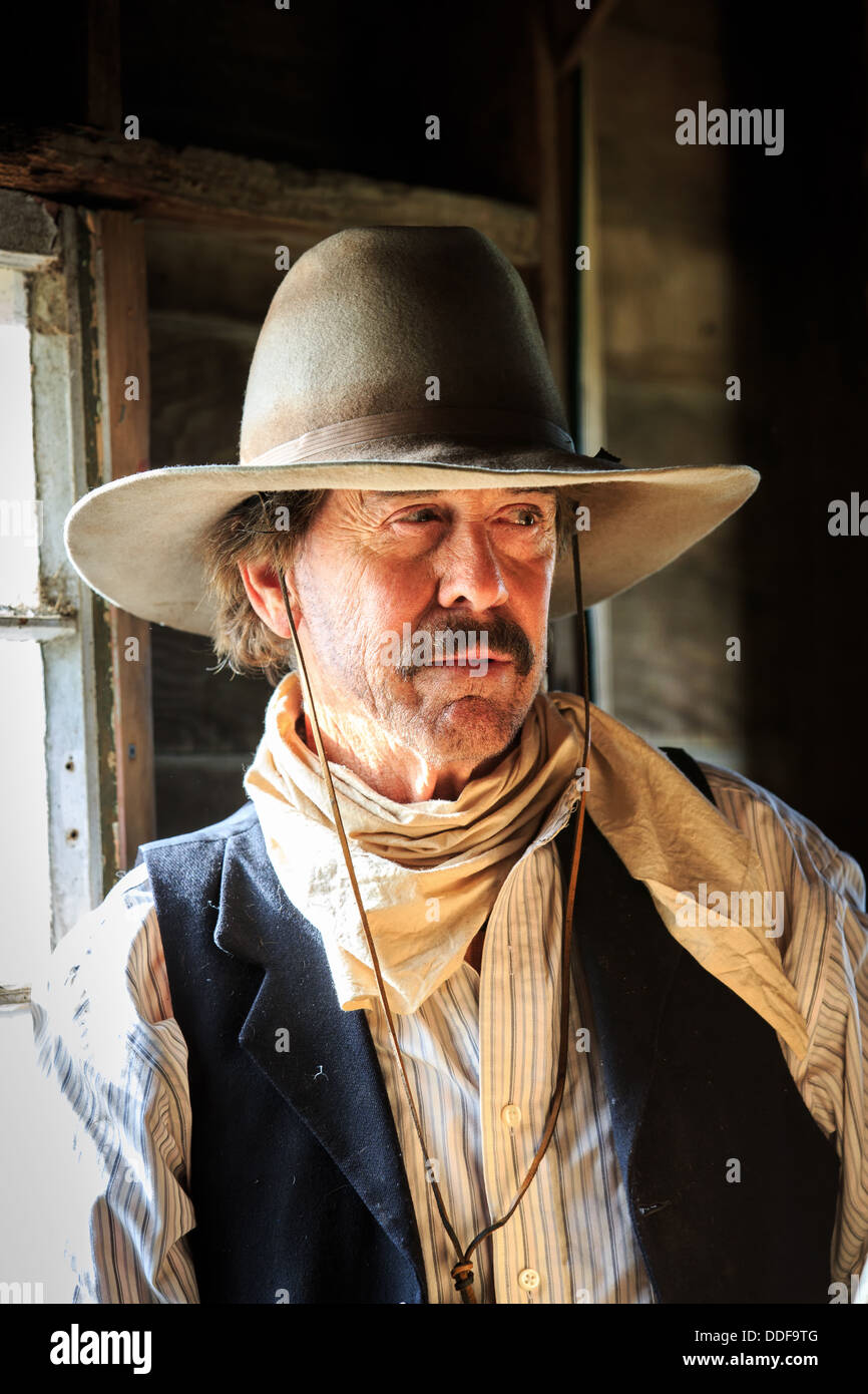 A portrait of a cowboy lit by a window Stock Photo