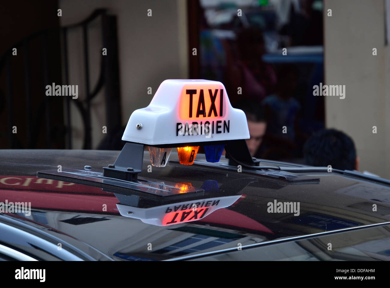 The 'for hire' sign on a Paris taxi Stock Photo