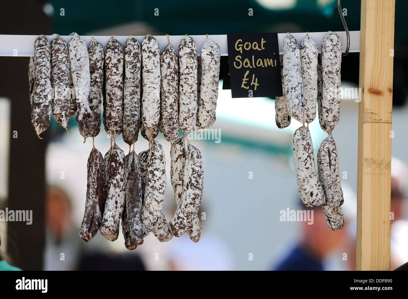 A traditional wooden salami slicer is seen close up on a market stall  during an agricultural and farming fair. Rustic butcher's tool for cutting  cured meats Stock Photo - Alamy