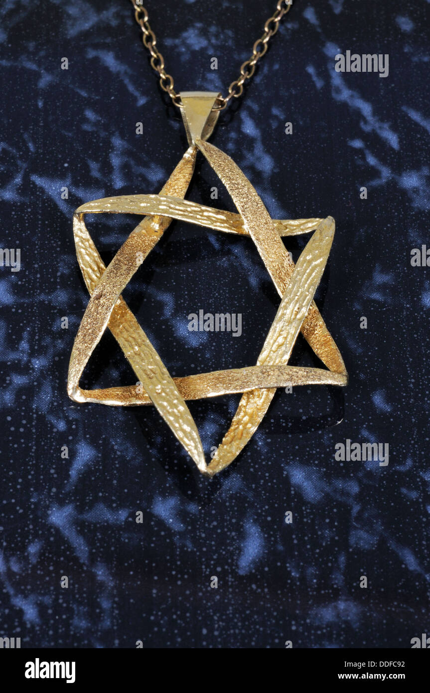 Star of David pendant against a dark background. Stock Photo